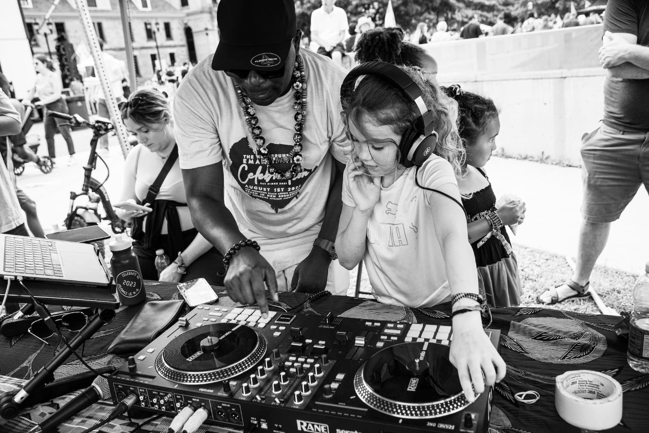 Black and white photo of people at a DJ station
