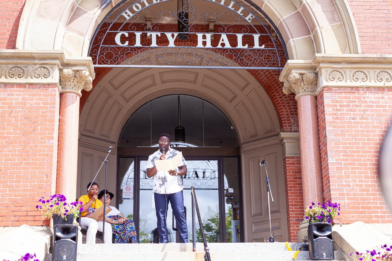 Photo of a speaker in front of City Hall on Emancipation Day